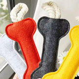 close up view of felt bone shape dog chew toy with rope