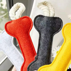 close up view of  felt bone shape dog chew toy with rope